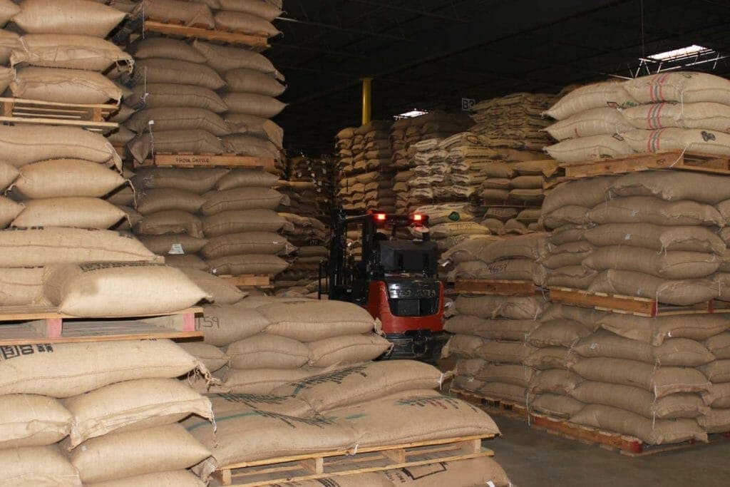 pallets of green coffee bags and a forklift at the Royal New York warehouse