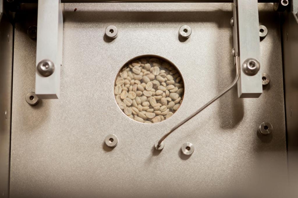 green coffee being roasted in coffee roaster